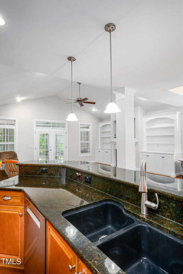 1218 Crystalwater Dr, Fuquay Varina, NC 27526 - kitchen featuring a sink, dishwasher, ceiling fan, brown cabinetry, and dark stone counters