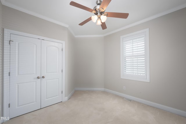 1218 Crystalwater Dr, Fuquay Varina, NC 27526 - unfurnished bedroom with ornamental molding, light carpet, baseboards, a closet, and a ceiling fan