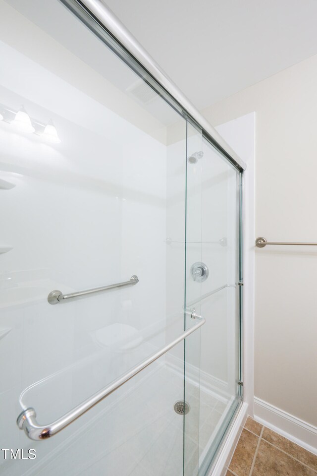 1218 Crystalwater Dr, Fuquay Varina, NC 27526 - bathroom with a shower stall, baseboards, and tile patterned floors
