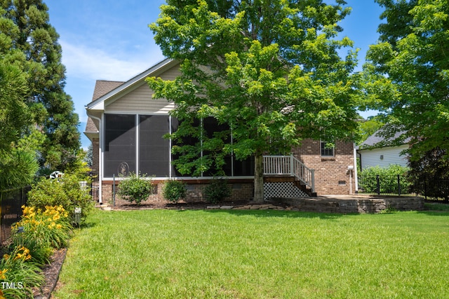 1218 Crystalwater Dr, Fuquay Varina, NC 27526 - rear view of property featuring brick siding and a sunroom