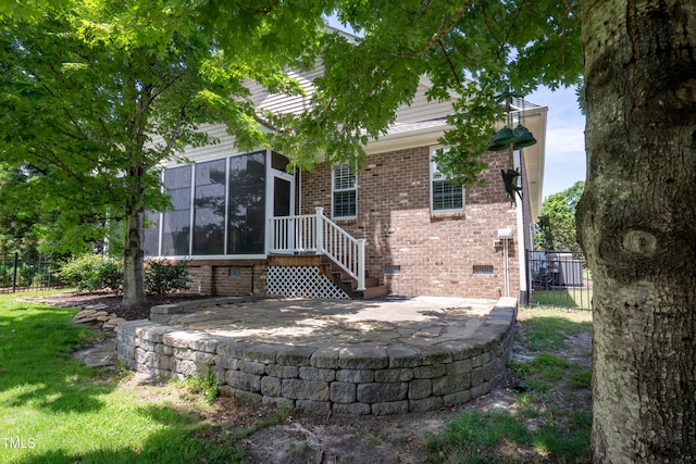 1218 Crystalwater Dr, Fuquay Varina, NC 27526 - back of house with a sunroom, brick siding, a patio area, and crawl space