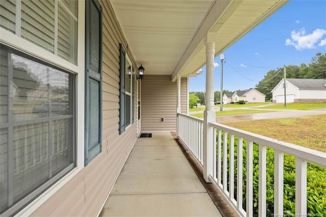 balcony featuring covered porch and a residential view