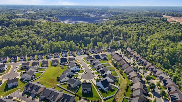 2096 Dowell Ct, Burlington, NC 27215 - aerial view of property's location featuring a heavily wooded area, nearby suburban area, and a large body of water