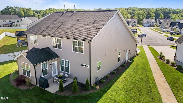 2096 Dowell Ct, Burlington, NC 27215 - back of property featuring a residential view, a lawn, and a patio area