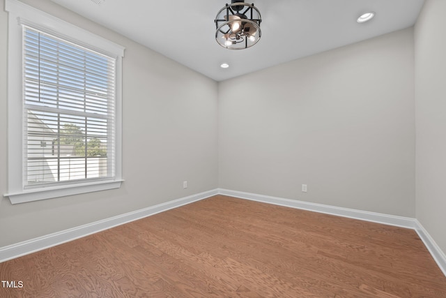 2096 Dowell Ct, Burlington, NC 27215 - empty room with a chandelier, wood finished floors, baseboards, and recessed lighting
