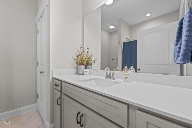 2096 Dowell Ct, Burlington, NC 27215 - bathroom featuring marble look tile flooring, vanity, and baseboards