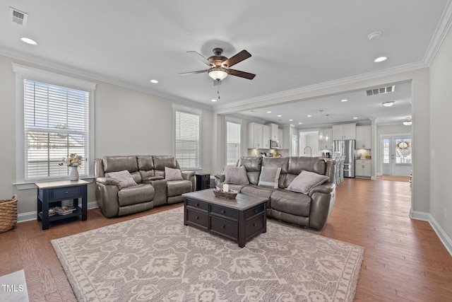 2096 Dowell Ct, Burlington, NC 27215 - living room featuring ceiling fan, ornamental molding, light wood-style flooring, baseboards, and recessed lighting