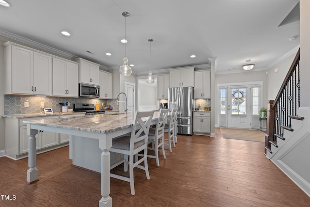 2096 Dowell Ct, Burlington, NC 27215 - kitchen with stainless steel appliances, ornamental molding, backsplash, a kitchen breakfast bar, and a sink