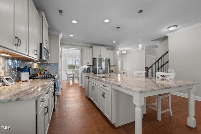 2096 Dowell Ct, Burlington, NC 27215 - kitchen with stainless steel appliances, ornamental molding, a kitchen bar, backsplash, and a sink