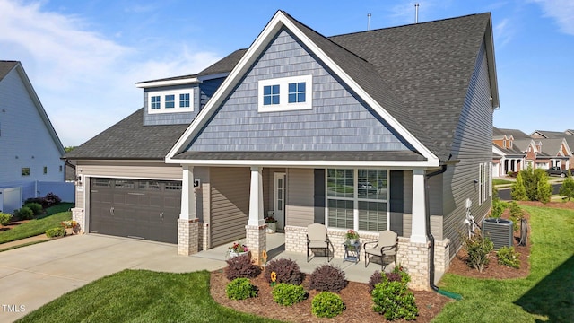 2096 Dowell Ct, Burlington, NC 27215 - view of front of house with a porch, a shingled roof, central air condition unit, concrete driveway, and an attached garage