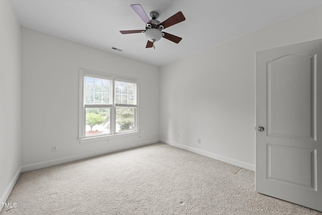 empty room with baseboards, light colored carpet, and ceiling fan