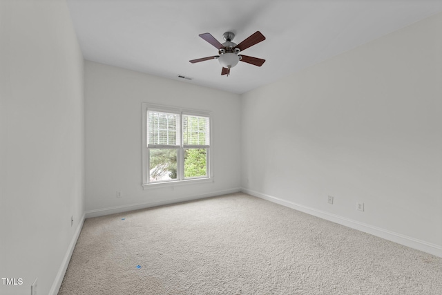 empty room featuring baseboards, carpet, and a ceiling fan