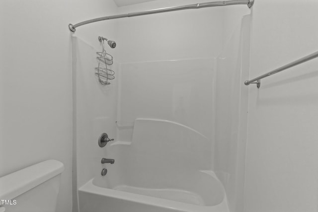 bathroom with toilet and  shower combination