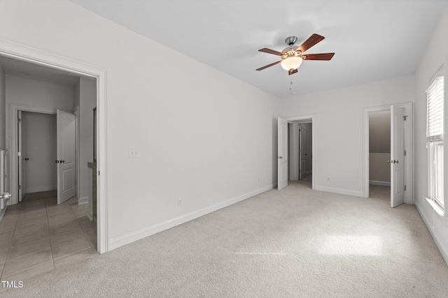 unfurnished bedroom with baseboards, light carpet, and ceiling fan
