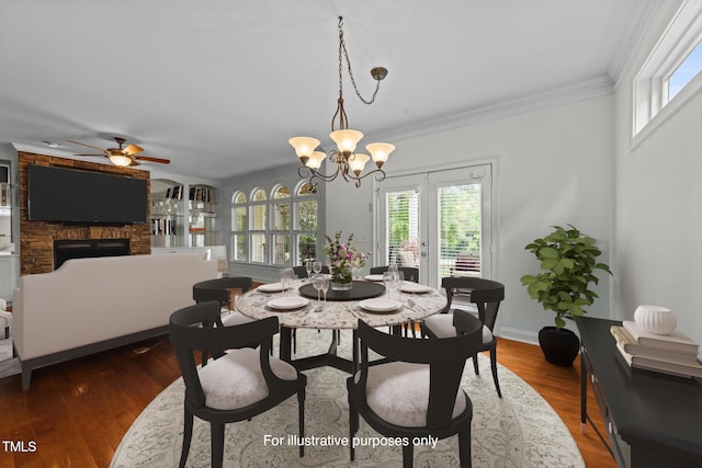 12217 Beestone Ln, Raleigh, NC 27614 - dining room with plenty of natural light, a fireplace, crown molding, ceiling fan, and dark wood finished floors