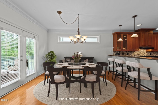 12217 Beestone Ln, Raleigh, NC 27614 - dining area featuring a chandelier, light wood-type flooring, and crown molding