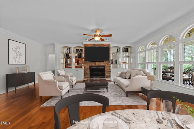 12217 Beestone Ln, Raleigh, NC 27614 - living room featuring wood finished floors, ceiling fan, ornamental molding, a fireplace, and built in features