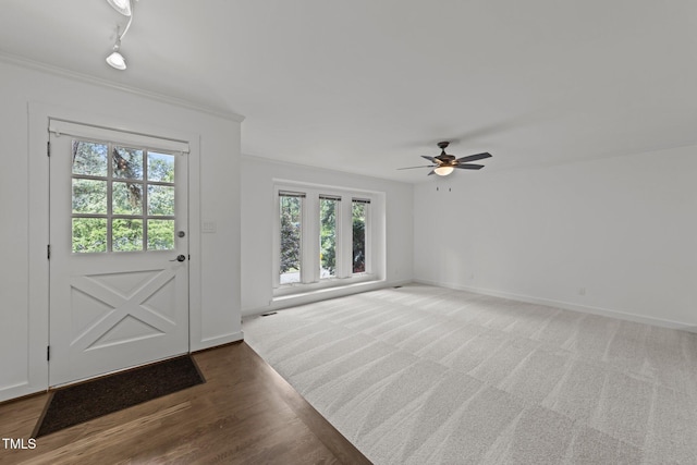 entrance foyer with healthy amount of natural light, ceiling fan, baseboards, and crown molding