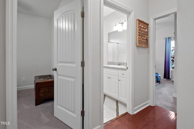 100 Jonathans Pl, Goldsboro, NC 27534 - corridor with a sink, baseboards, and light wood-type flooring