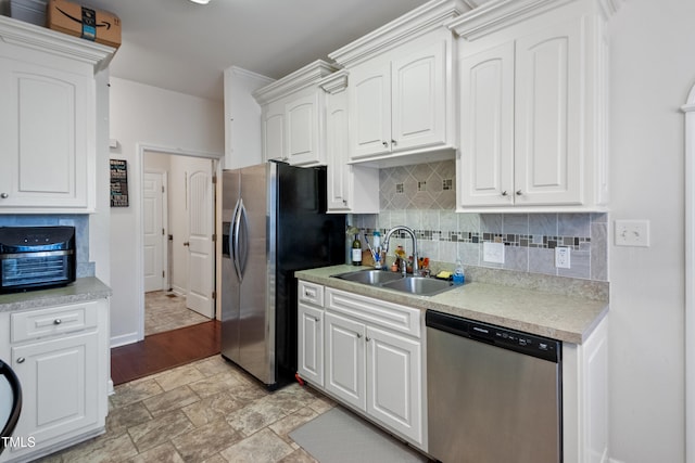 100 Jonathans Pl, Goldsboro, NC 27534 - kitchen with stainless steel appliances, a sink, baseboards, and tasteful backsplash