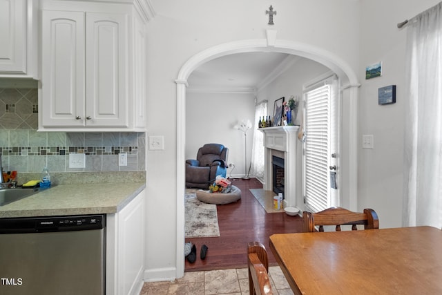 100 Jonathans Pl, Goldsboro, NC 27534 - kitchen with dishwasher, crown molding, light countertops, a fireplace with flush hearth, and arched walkways