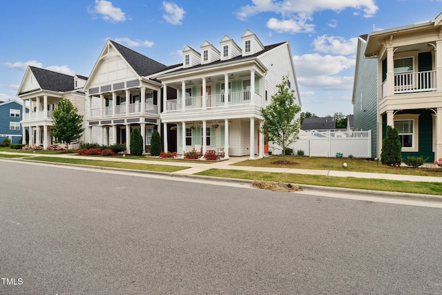 view of front of property featuring a balcony and fence