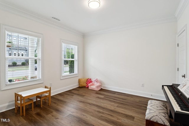 game room with ornamental molding, dark wood-style flooring, and baseboards