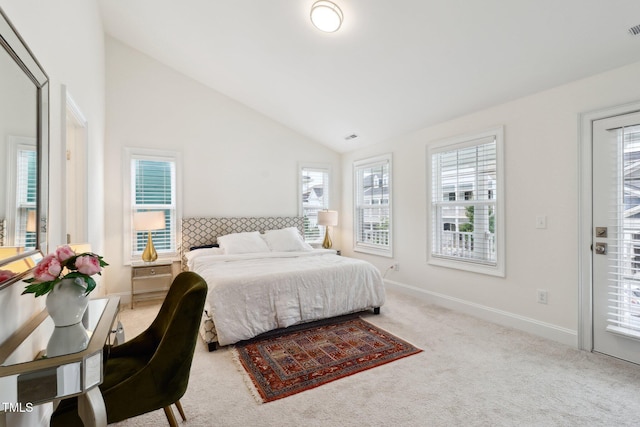 carpeted bedroom featuring vaulted ceiling and baseboards