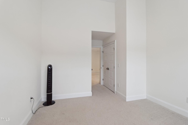 carpeted spare room featuring baseboards