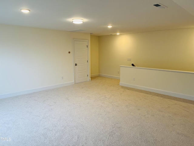 spare room with light carpet, baseboards, and recessed lighting