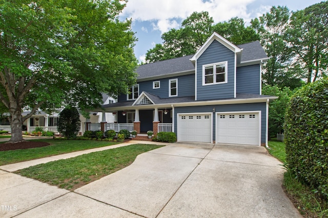 view of front of property featuring covered porch, a garage, roof with shingles, driveway, and a front lawn