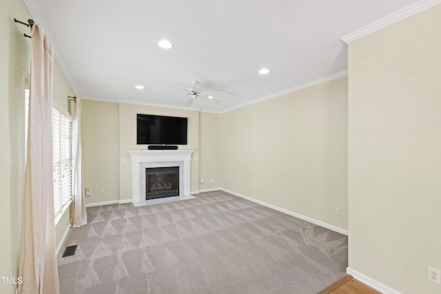 unfurnished living room featuring ceiling fan, baseboards, a fireplace with flush hearth, recessed lighting, and crown molding