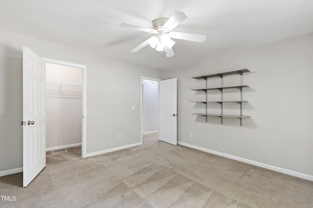unfurnished bedroom with carpet flooring, baseboards, and a ceiling fan