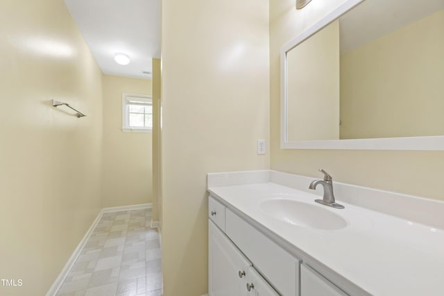 bathroom with baseboards, tile patterned floors, and vanity