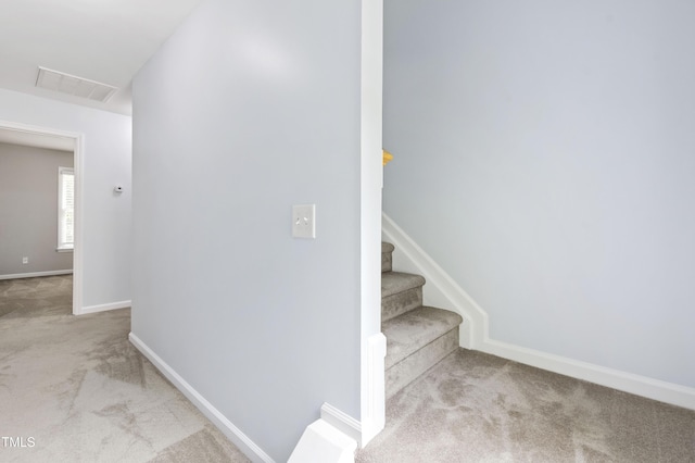 stairs featuring carpet and baseboards