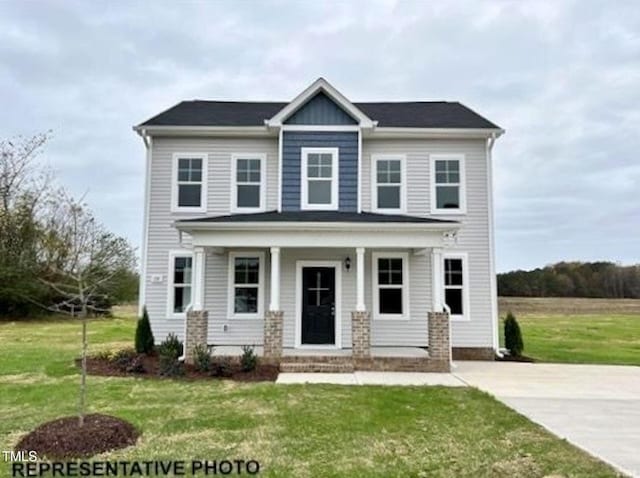 view of front of house featuring covered porch and a front lawn