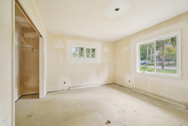 unfurnished bedroom with a baseboard radiator, baseboards, and a closet