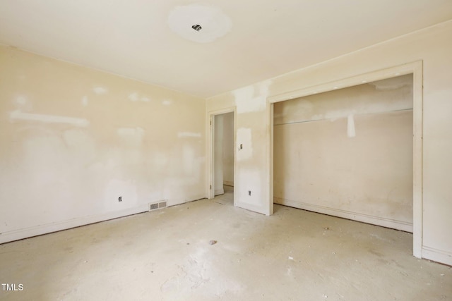 unfurnished bedroom featuring a closet and concrete floors