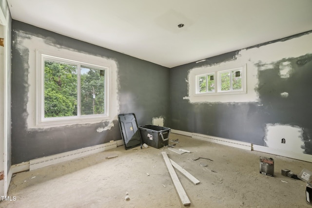 unfurnished room with baseboard heating