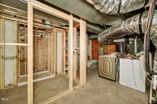 unfinished below grade area with washing machine and clothes dryer