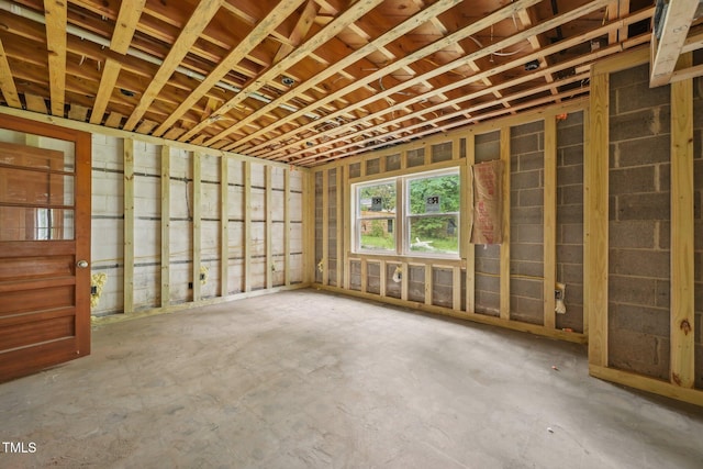 miscellaneous room with unfinished concrete flooring