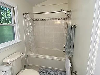 full bath featuring shower / tub combo, toilet, and vanity