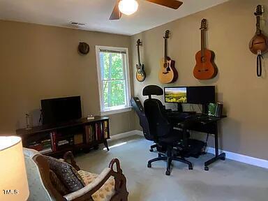 home office featuring a ceiling fan, baseboards, and carpet