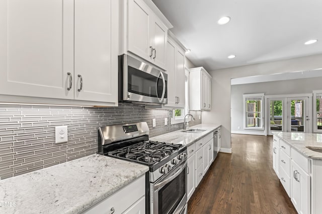 3914 Old Chapel Hill Rd, Durham, NC 27707 - kitchen with appliances with stainless steel finishes, a sink, backsplash, white cabinets, and recessed lighting