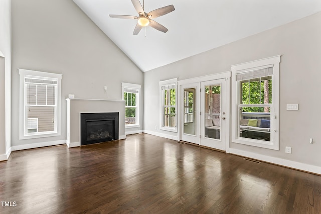 3914 Old Chapel Hill Rd, Durham, NC 27707 - unfurnished living room with high vaulted ceiling, a ceiling fan, a glass covered fireplace, baseboards, and wood finished floors