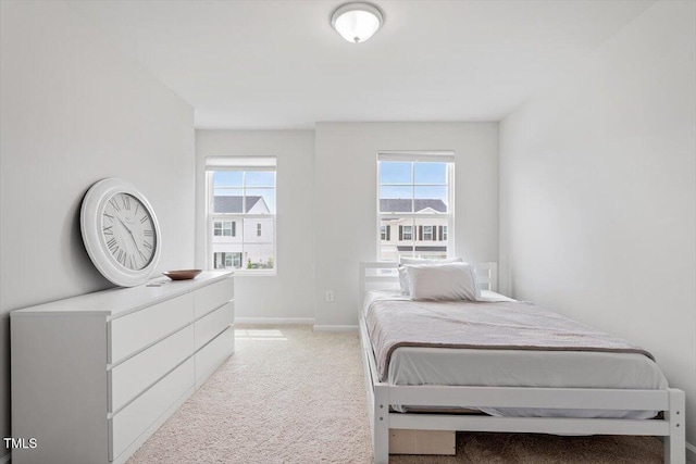 637 Marrian Dr, Clayton, NC 27520 - bedroom featuring light colored carpet, multiple windows, and baseboards
