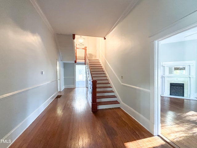 208 Glenn St, Franklinton, NC 27525 - stairs featuring hardwood / wood-style flooring, baseboards, ornamental molding, a fireplace, and a chandelier