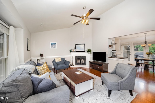 200 W Woodcroft Pkwy Unit 57B, Durham, NC 27713 - living room with light wood-style floors, ceiling fan, a fireplace with raised hearth, and high vaulted ceiling