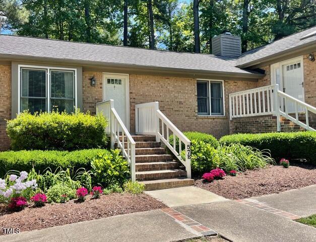 200 W Woodcroft Pkwy Unit 57B, Durham, NC 27713 - property entrance with brick siding and a chimney