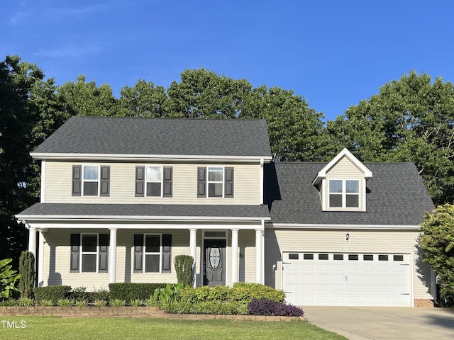 395 Wyndham Place Dr, Fuquay Varina, NC 27526 - view of front of home featuring covered porch, an attached garage, driveway, and roof with shingles